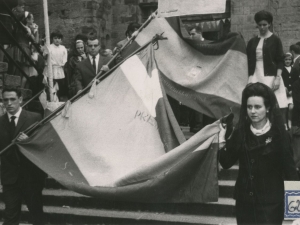 Desfile de las banderas hacia el Ayuntamiento. Al fondo se ve la entrada a la iglesia de San Juan Bautista